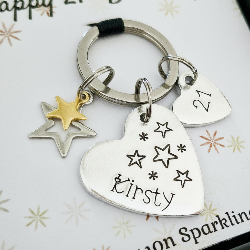 Keychain with heart-shaped keyring and star charms on a white background